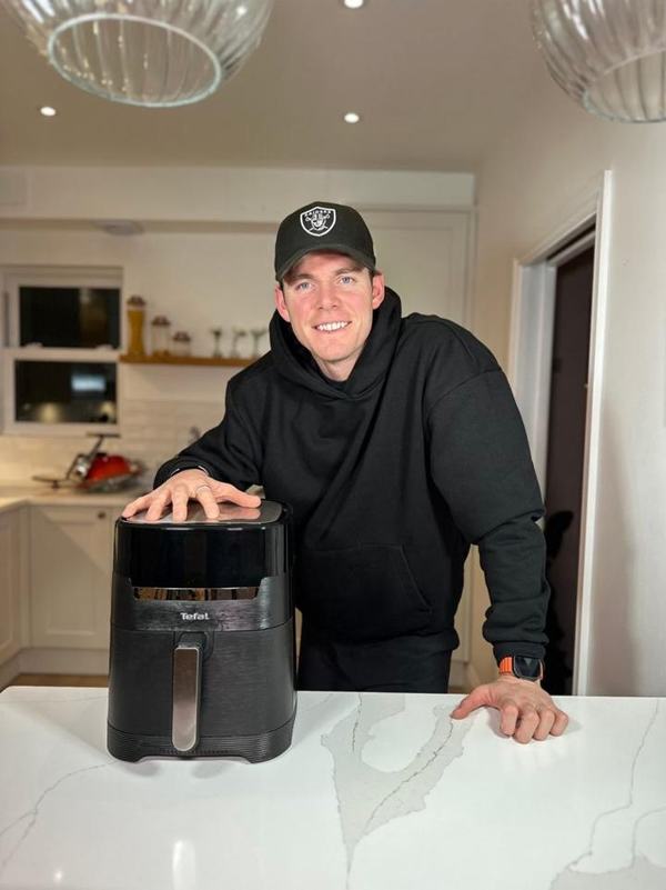 Paddy smiling in his kitchen